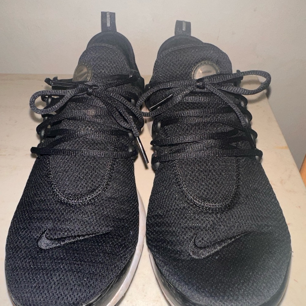 Size 11 woman’s black Nike panda prestos